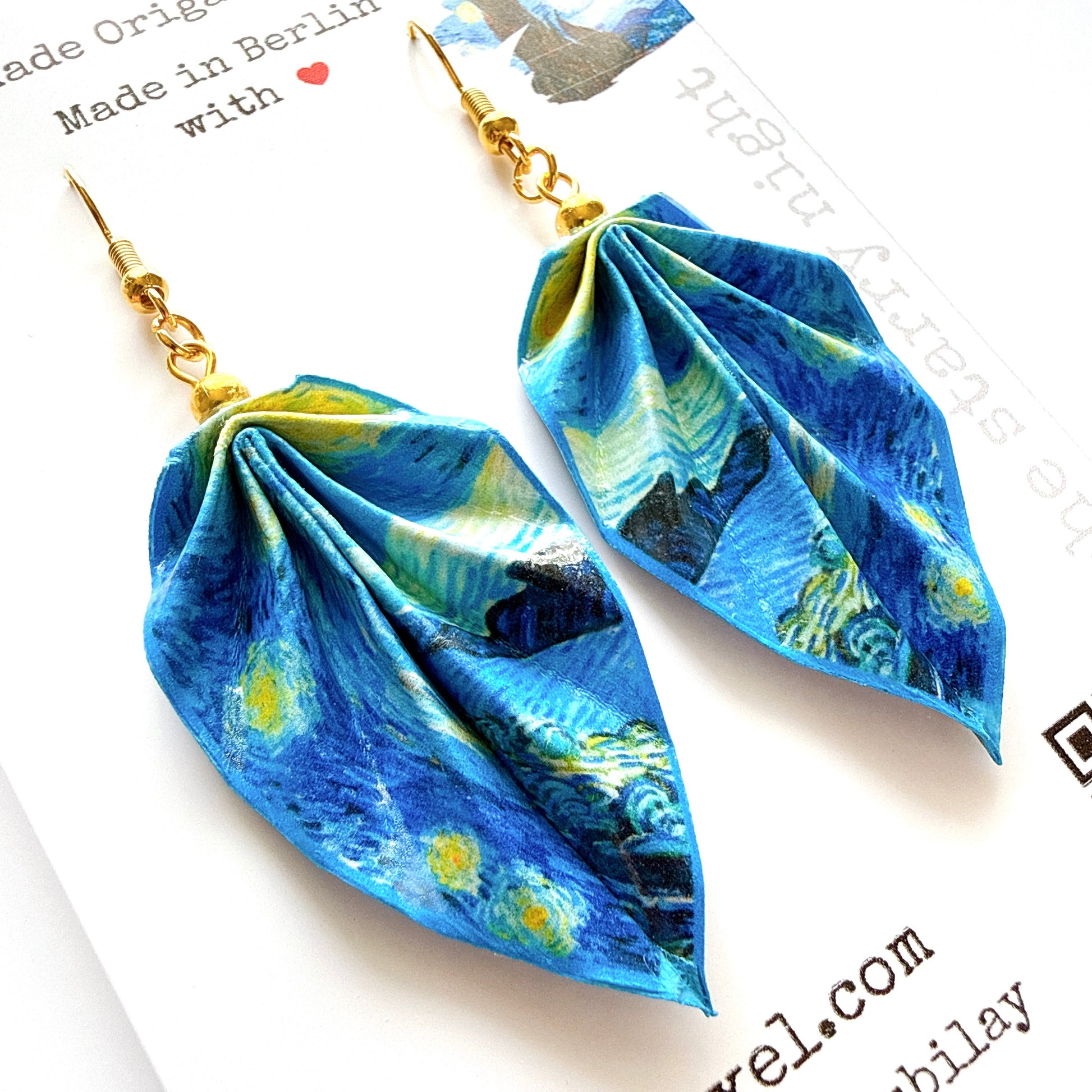 Blue and green patterned earrings on a white background