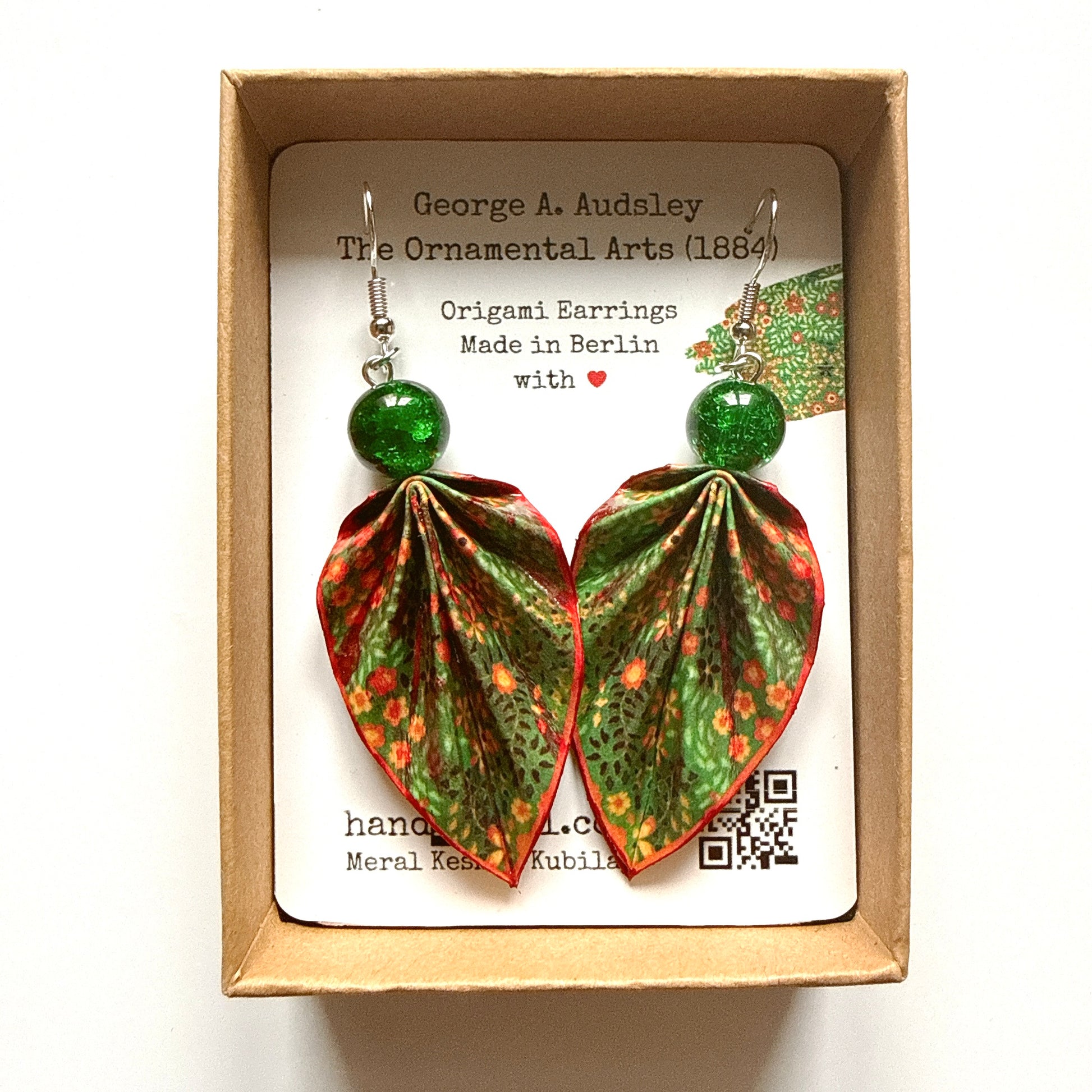 Origami earrings in a box with a label