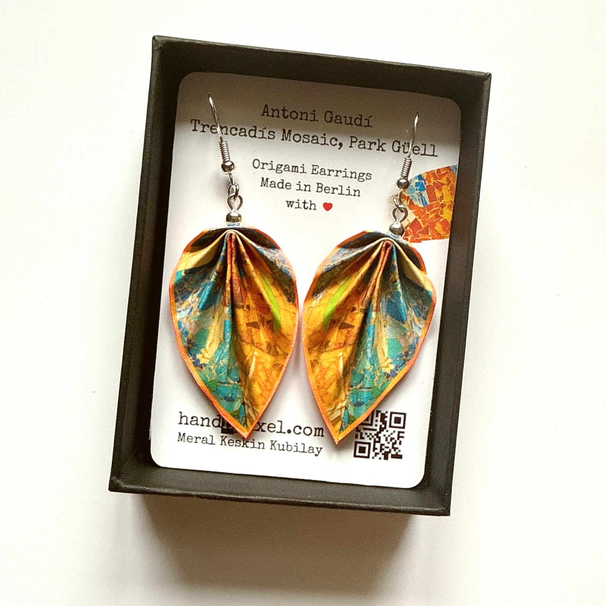Pair of origami earrings in a box with a label