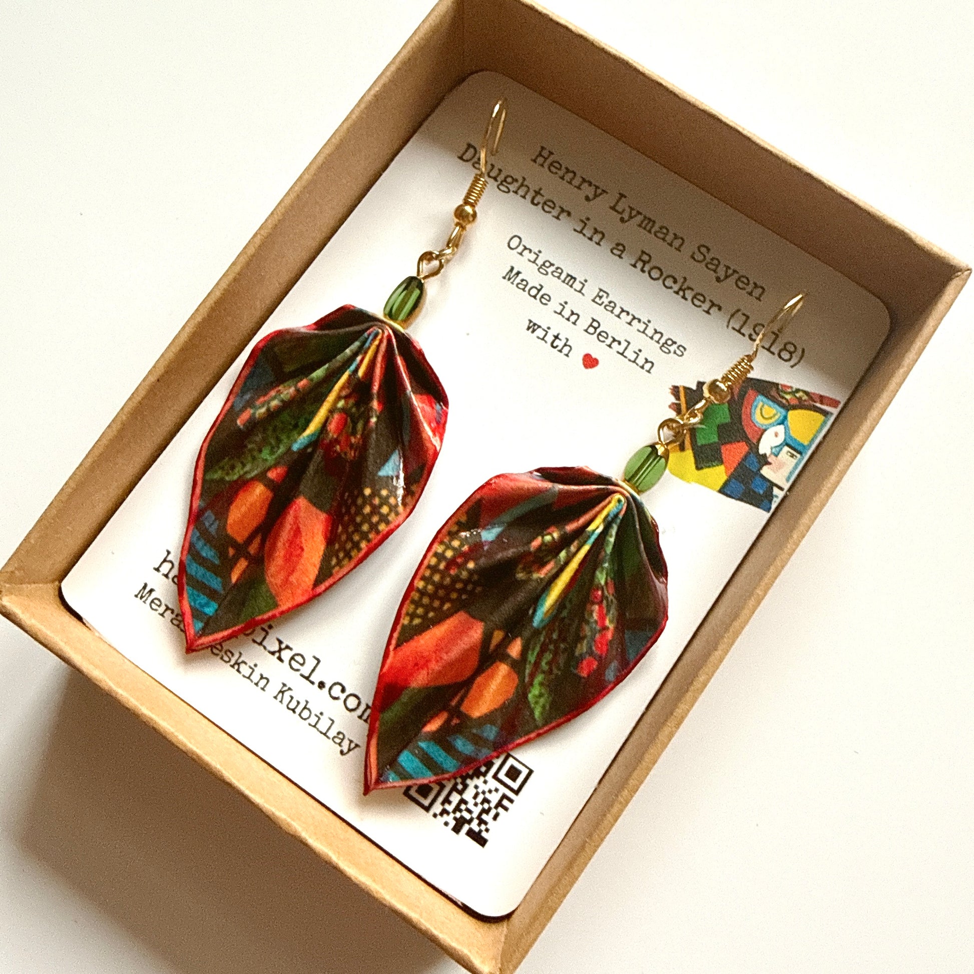 Colorful leaf-shaped earrings in a box with a card