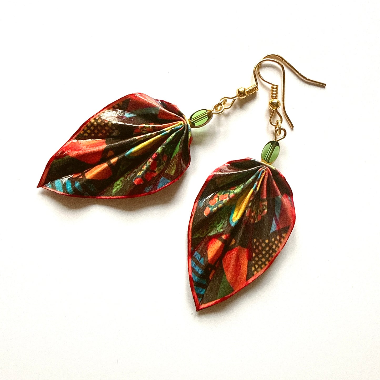 Leaf-shaped earrings with colorful patterns on a white background