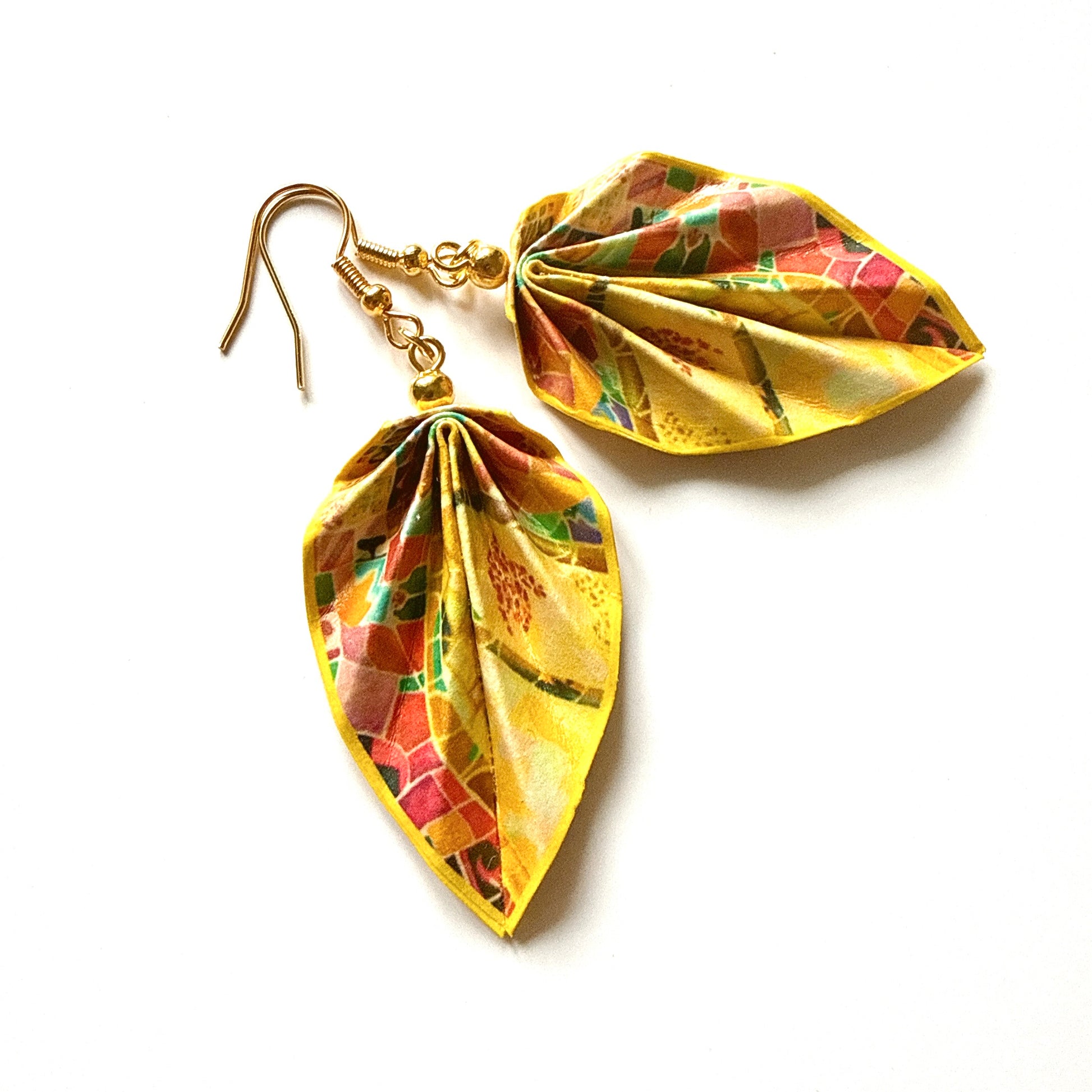 Leaf-shaped earrings with gold and multicolored design on a white background