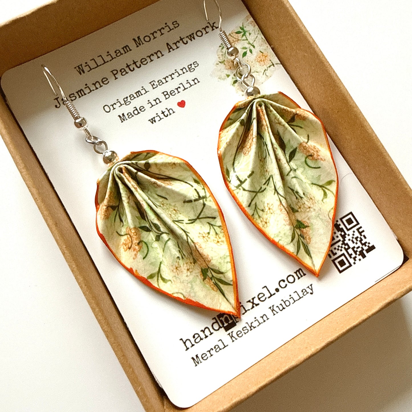 Jasmine pattern earrings in a box with a card displaying the brand and design details.